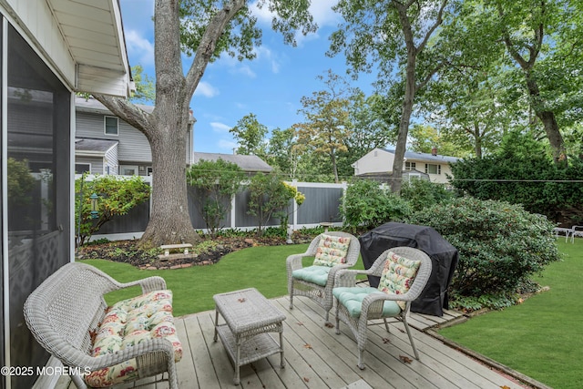 deck with a fenced backyard and a yard