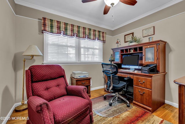 office space with crown molding, baseboards, a ceiling fan, and wood finished floors
