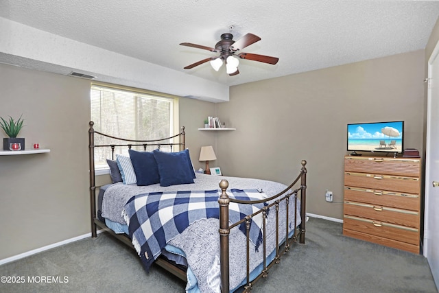 carpeted bedroom with a textured ceiling, visible vents, ceiling fan, and baseboards