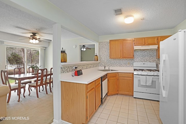 kitchen with white appliances, a textured ceiling, under cabinet range hood, and ceiling fan
