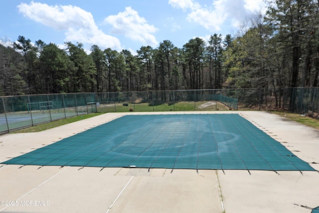 view of swimming pool with a patio, a fenced in pool, and fence