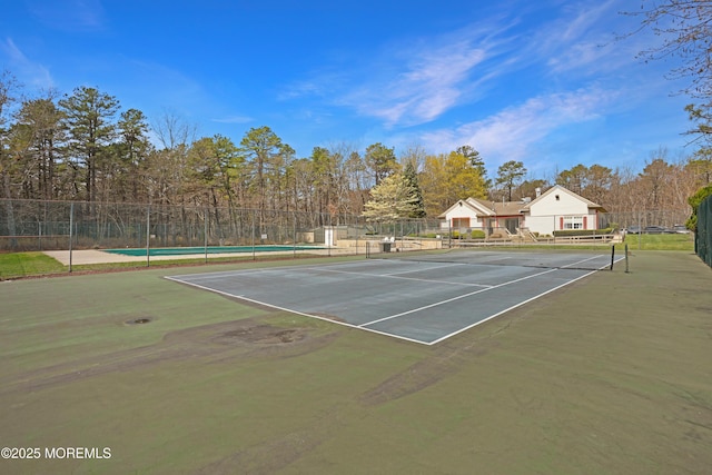 view of sport court featuring fence