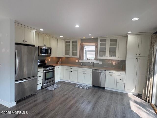 14 Jonathan Dr, Manahawkin, NJ 08050 - kitchen featuring appliances with stainless steel finishes, dark wood finished floors, recessed lighting, decorative backsplash, and glass insert cabinets