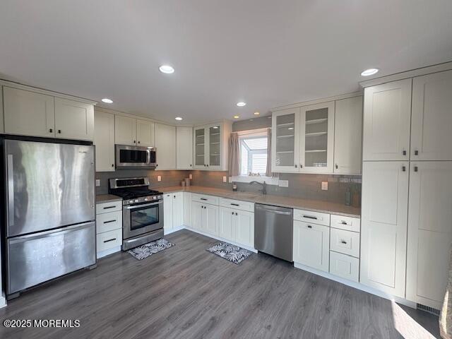 14 Jonathan Dr, Manahawkin, NJ 08050 - kitchen featuring appliances with stainless steel finishes, white cabinets, glass insert cabinets, wood finished floors, and recessed lighting