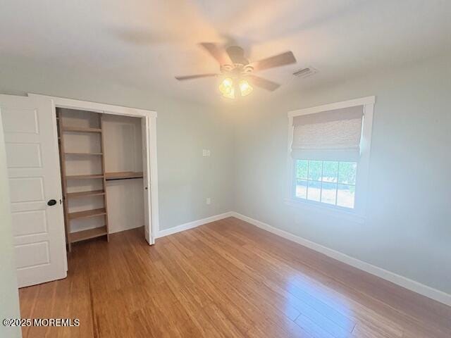 14 Jonathan Dr, Manahawkin, NJ 08050 - unfurnished bedroom with a closet, wood finished floors, and a ceiling fan