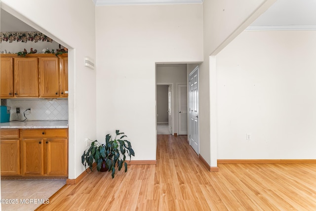 87 Halsted Dr, Manchester, NJ 08759 - interior space with brown cabinetry, light countertops, light wood finished floors, and backsplash