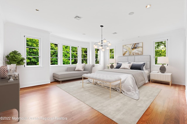bedroom featuring visible vents, ornamental molding, a notable chandelier, and multiple windows