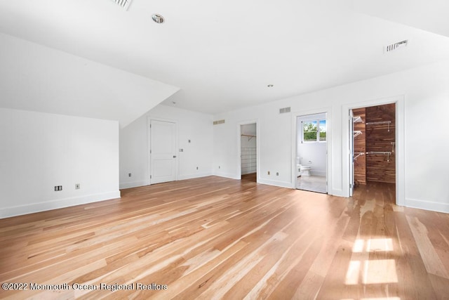 bonus room with visible vents, light wood-style flooring, and baseboards