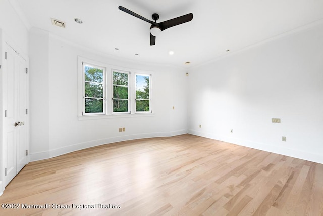 unfurnished bedroom featuring light wood finished floors, visible vents, ornamental molding, and baseboards