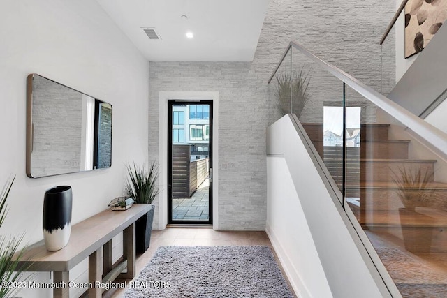 interior space featuring visible vents, tile patterned flooring, and stairs
