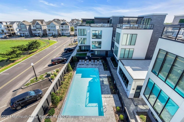 view of swimming pool with a residential view