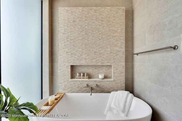 bathroom featuring a soaking tub