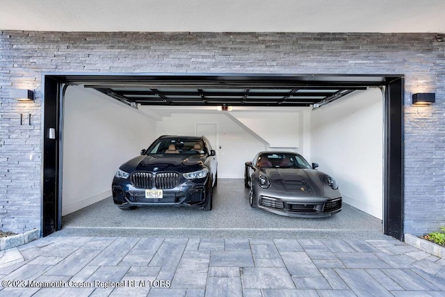 view of vehicle parking featuring a garage