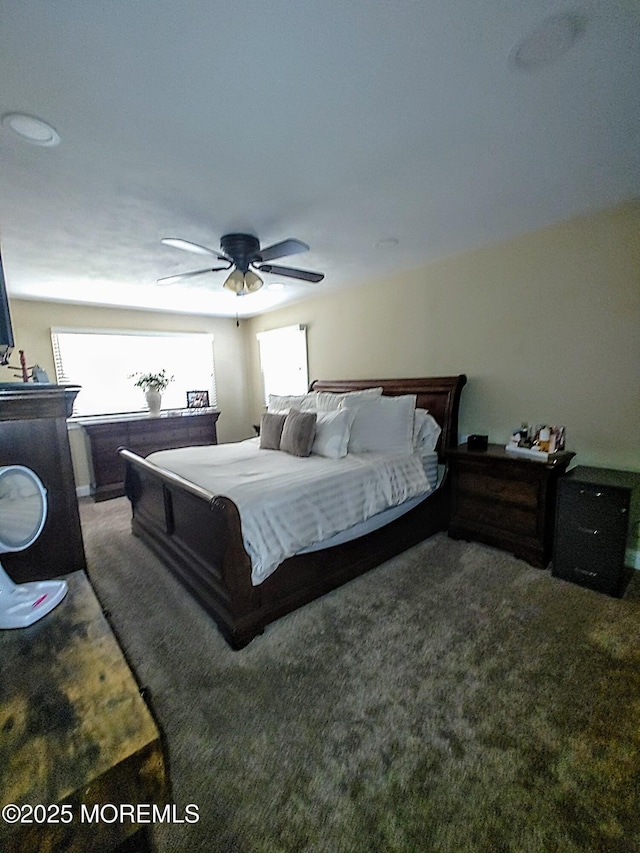 bedroom with ceiling fan and carpet flooring