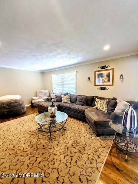 living room with recessed lighting, ornamental molding, and wood finished floors