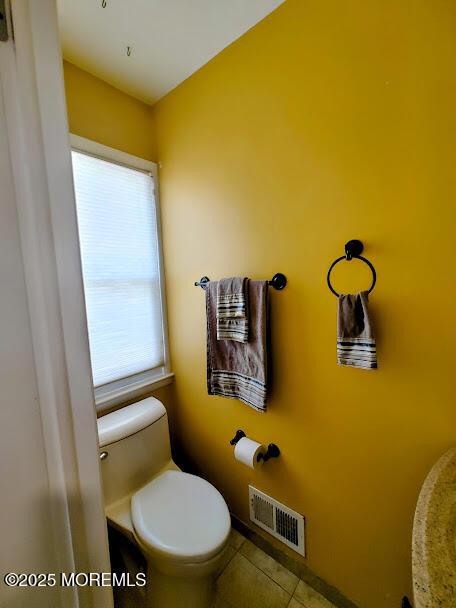 bathroom featuring toilet, tile patterned floors, and visible vents