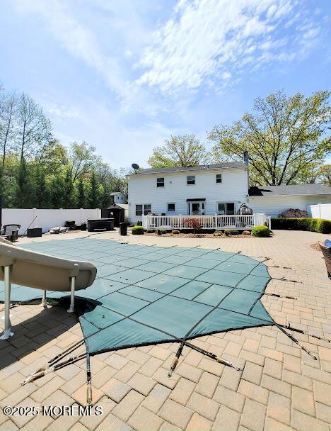 view of pool featuring fence, a wooden deck, a patio area, and a fenced in pool