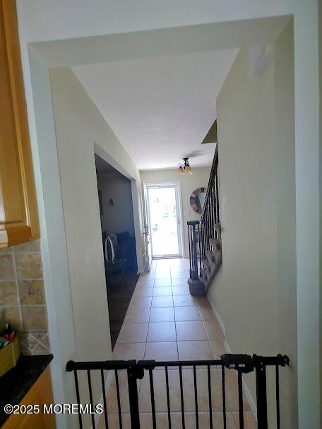 interior space featuring baseboards and tile patterned flooring