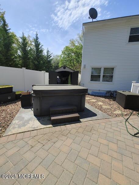 view of patio featuring a fenced backyard and a hot tub