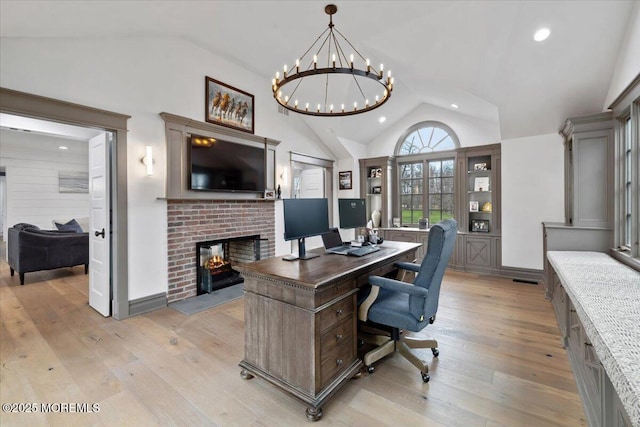 home office featuring recessed lighting, an inviting chandelier, a brick fireplace, light wood-type flooring, and high vaulted ceiling