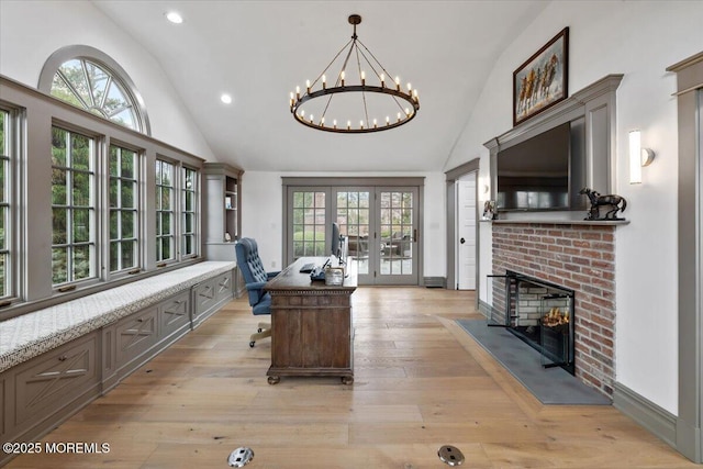 office space with a notable chandelier, recessed lighting, a brick fireplace, french doors, and high vaulted ceiling