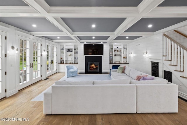 living room featuring recessed lighting, coffered ceiling, and a fireplace