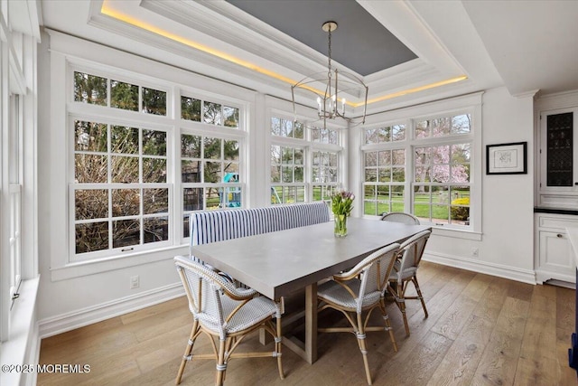 sunroom featuring a notable chandelier