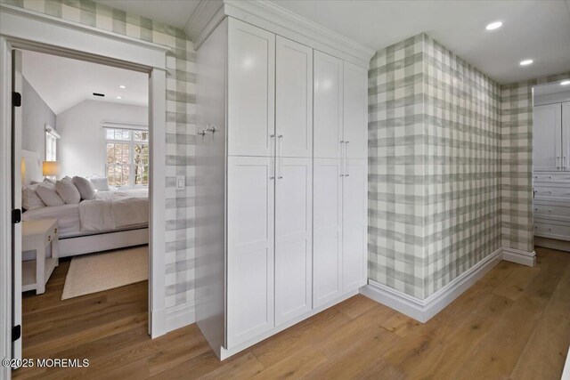bathroom featuring wallpapered walls, wood finished floors, and ensuite bath