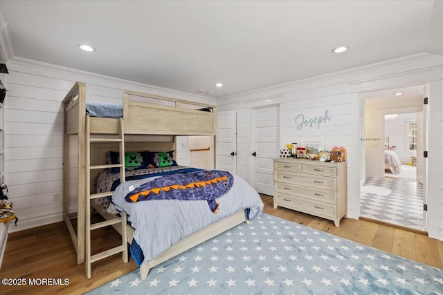bedroom featuring wood finished floors, recessed lighting, and ornamental molding