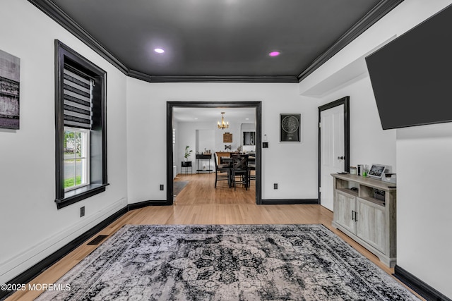125 Broad St, Eatontown, NJ 07724 - interior space featuring ornamental molding, baseboards, a chandelier, and light wood-style floors