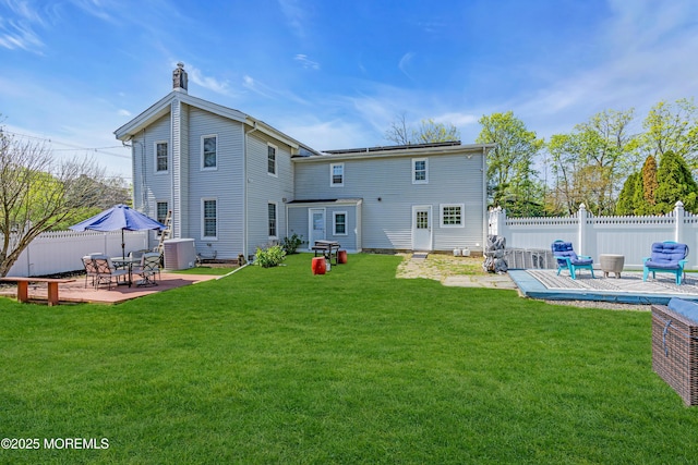 125 Broad St, Eatontown, NJ 07724 - back of house with a chimney, a yard, fence, central air condition unit, and a patio