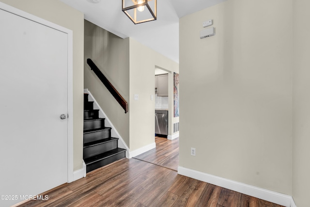foyer featuring stairway, baseboards, wood finished floors, and visible vents