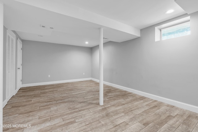 basement featuring recessed lighting, baseboards, visible vents, and light wood-type flooring