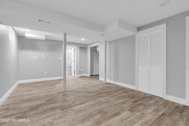 finished below grade area featuring recessed lighting, baseboards, light wood finished floors, and visible vents