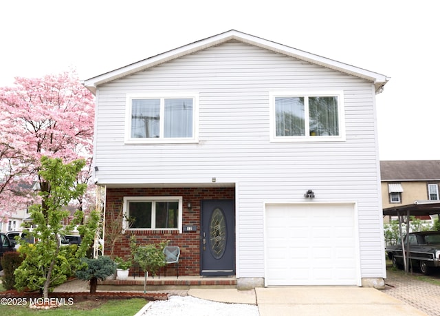 12 Yates Ave, South River, NJ 08882 - view of front of house with a garage, brick siding, and driveway