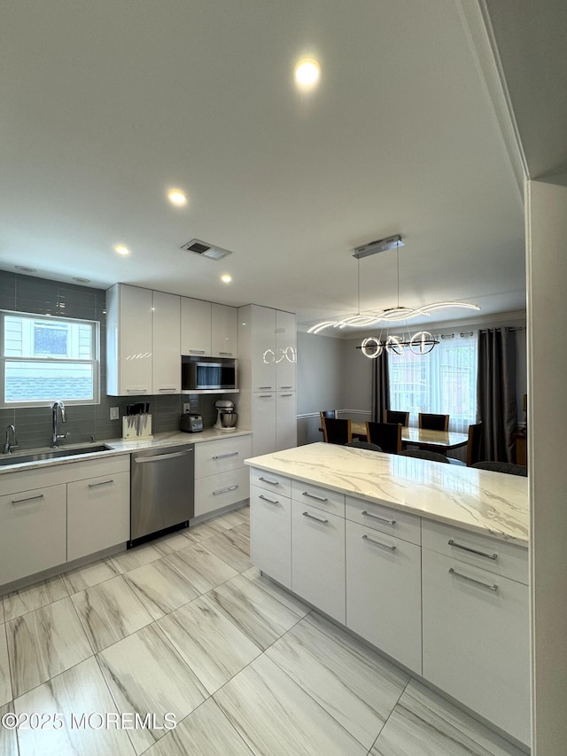 12 Yates Ave, South River, NJ 08882 - kitchen with appliances with stainless steel finishes, white cabinetry, decorative backsplash, modern cabinets, and recessed lighting