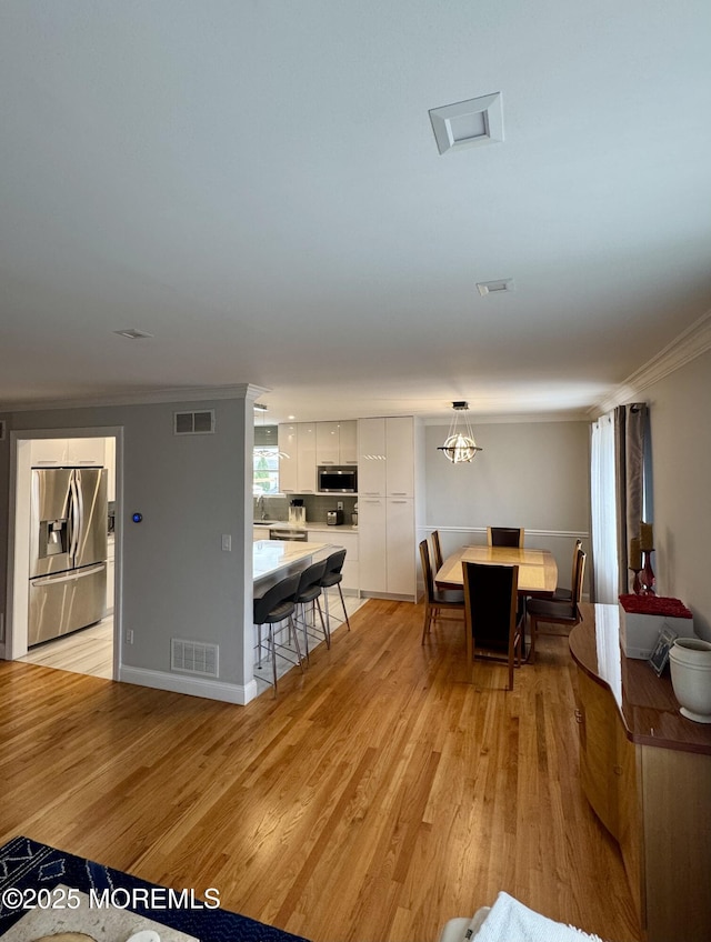 12 Yates Ave, South River, NJ 08882 - dining space with ornamental molding and light wood-style flooring