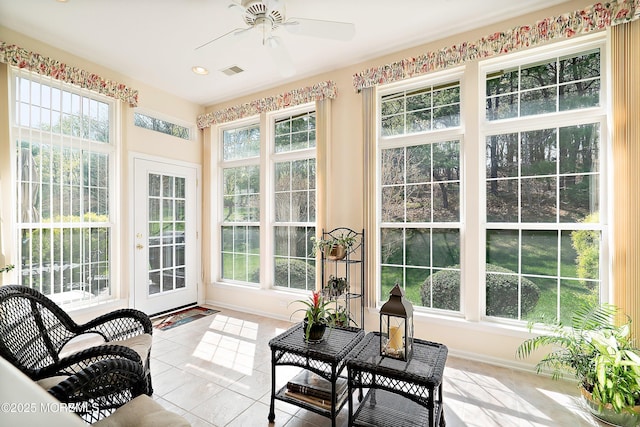 sunroom with tile patterned flooring, visible vents, and baseboards