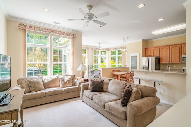 carpeted living room with recessed lighting, a sink, crown molding, a ceiling fan, and visible vents