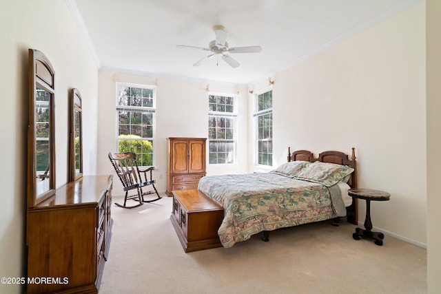 bedroom featuring ornamental molding, a ceiling fan, carpet flooring, and baseboards