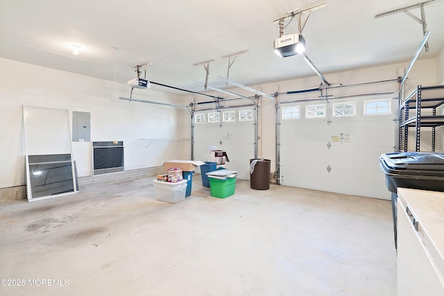 garage with electric panel and a garage door opener