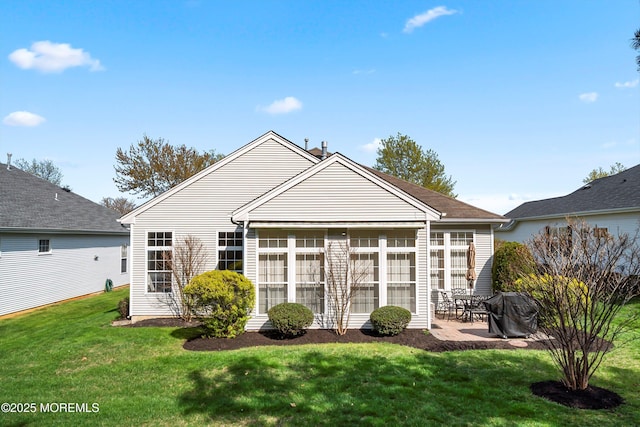 back of property featuring a patio and a yard