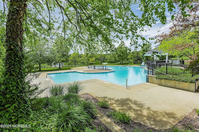 pool featuring a patio area and fence