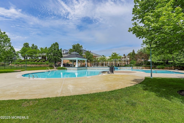 pool with a patio, fence, a gazebo, and a lawn