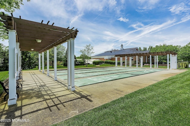 view of home's community with a lawn and shuffleboard