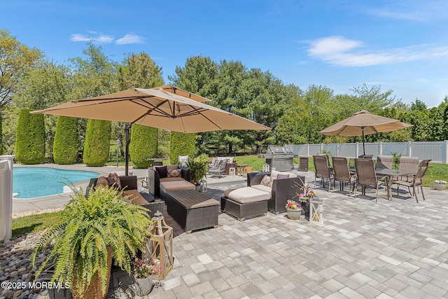 view of patio / terrace featuring area for grilling, an outdoor living space, outdoor dining area, fence, and a fenced in pool