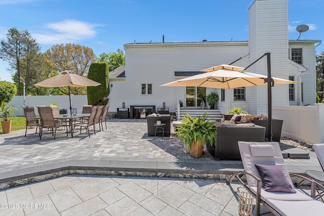 exterior space featuring fence, outdoor dining area, and outdoor lounge area