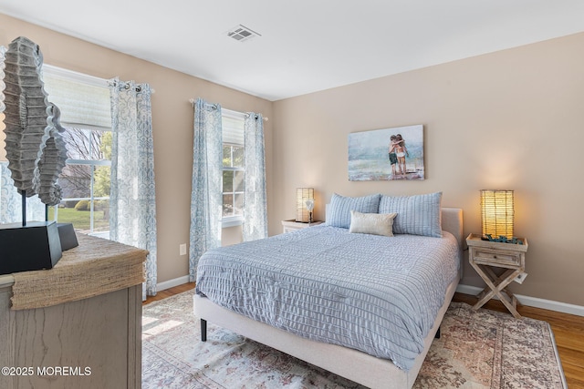 bedroom featuring visible vents, baseboards, and light wood-type flooring