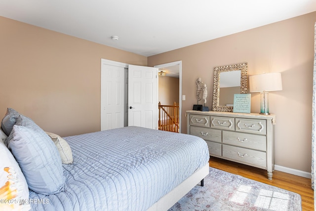 bedroom with baseboards and wood finished floors