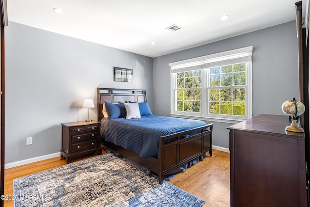bedroom featuring visible vents, recessed lighting, baseboards, and light wood-type flooring